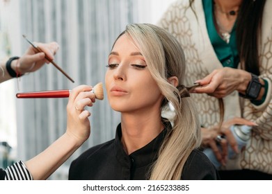 A Hairdresser And A Makeup Artist Together Prepare A Beautiful Model For A Photo Shoot. The Girl Gets Her Hair And Makeup Done In A Beauty Salon.