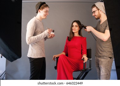 Hairdresser And Make-up Artist Work Together In Studio . Men Doing Makeup And Hairstyle For Woman. Creative Team Make Commercials. Photo School, Lookbook, Fashion Backstage Concept