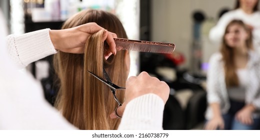 Hairdresser making stylish haircut with professional scissors in salon, closeup. Banner design - Powered by Shutterstock