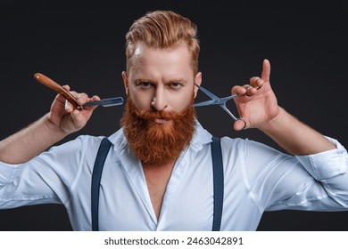 Hairdresser man. Professional barber man hold retro razor. Handsome hairstylist with haircut. Barbershop. Man hairdressing and barbering. Hairdresser at barbershop isolated on black. Barber scissors - Powered by Shutterstock