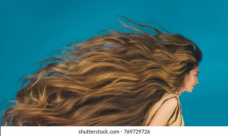 Hairdresser salon and barber. Beauty and fashion. Hair style and health. Woman with long healthy hair on blue background. Girl with beautiful hair, look.