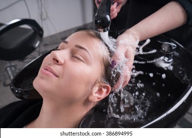 Hairdresser Salon. Woman During Hair Wash