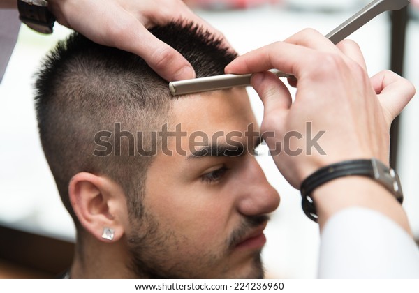 Hairdresser Shaving Mans Forehead Straight Razor Royalty Free