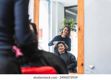 A hairdresser styles a client's hair using the mirror reflection, ensuring a precise look. Concept of meticulous hair care and client satisfaction. - Powered by Shutterstock