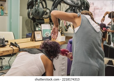 Hairdresser Styling A Client. Hairdresser At Her Work Station Styling And Drying The Hair Of A Mature Woman In The Beauty Salon.