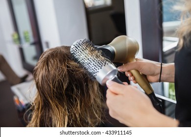 Hairdresser Styling Client's Hair In Salon - Shutterstock ID 433911145