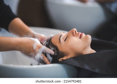 hairdresser washing client's hair at salon. happy young women customer relax and comfortable while washing hair, luxury hair spa by professional hairstylist - Powered by Shutterstock