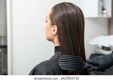 Hairdresser washing hair of a woman in a beauty salon