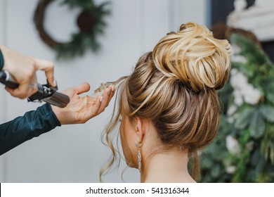 Hairdresser working at the beauty studio salon, making hair style.