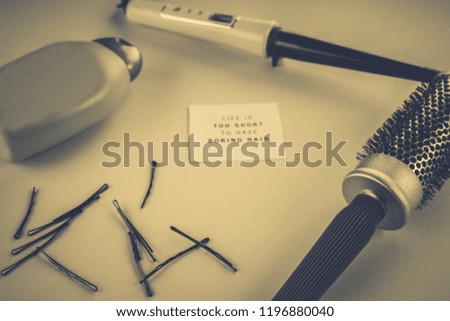 hairdresser's concept: hairbrush, plaice, hairpins on a blue background