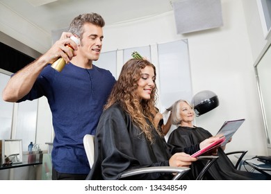 Hairdressers setting up customer's hair in beauty salon - Powered by Shutterstock