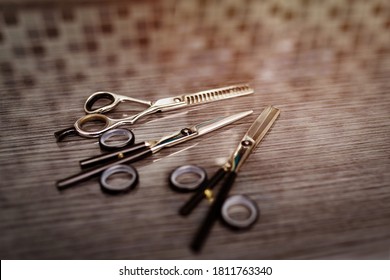 Hairdressing different scissors on table in professional hairdressing salon. Selective focus
