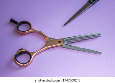 Hairdressing Scissors. Milling Rose Gold, In Open Form. The Blades Of Ordinary Clippers Are Visible. Solid Purple Background. Base, Banner, Postcard.