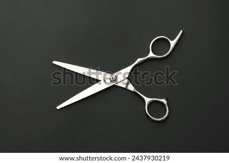 Hairdressing scissors on black background studio shot
