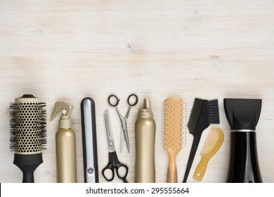 Hairdressing tools on wooden background with copy space at top
