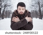 haired bearded man in cold winter snow park