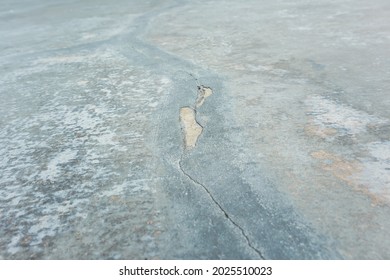 Hairline Crack Of Concrete. That Damage On Surface Floor Or Slab After Repair By Joint Filler, Plaster. ​Building Structure On Ground For Garage, Driveway Or Patio. Effect From Old, Aged And Earthquak