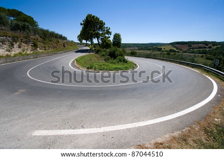 A hairpin bend on a road in the mountains of Toscany in Italy