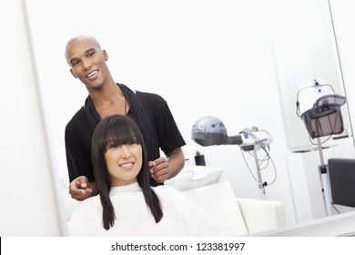 Hairstylist with female customer at beauty salon - Powered by Shutterstock