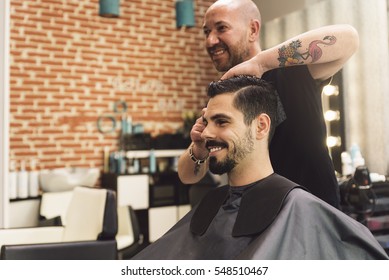 Hairstylist Making Men's Haircut To An Attractive Man In The Beauty Salon.