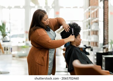 Hairstylist trimming the customer 39;s hair at a beauty salon - Powered by Shutterstock