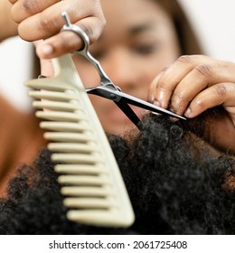 Hairstylist trimming the customerhair at a beauty salon - Powered by Shutterstock