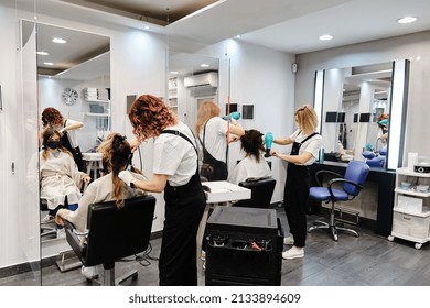 Hairstylists working with customers at the hair salon. - Powered by Shutterstock