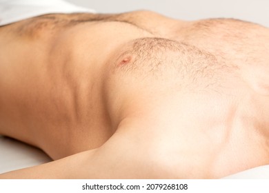 Hairy Body, Stomach, And Chest Of A Man Lying Before Epilation