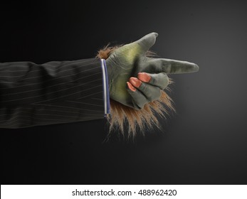 Hairy Hand Pointing Against Dark Background