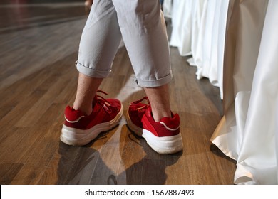 Hairy Legs Of A Man In Red Sneakers