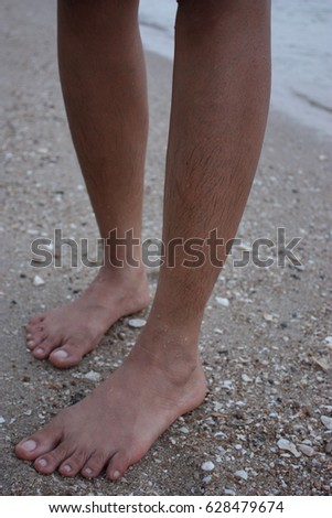 Hairy legs women be wet stand on the beach stand .selective focus and nois.