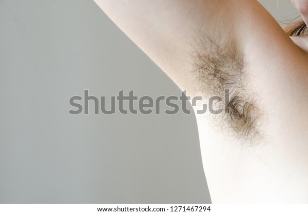 hairy woman\'s armpit, close-up, unshaven, a lot of\
hair on the armpit
