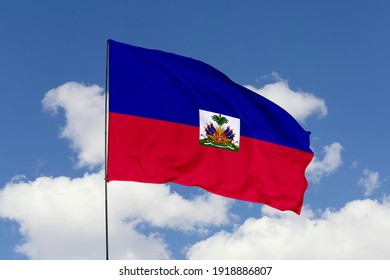 Haiti flag isolated on the blue sky with clipping path. close up waving flag of Haiti. flag symbols of Haiti.