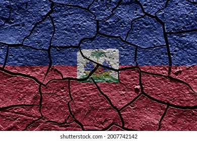 Haiti flag on a mud texture of dry crack on the ground