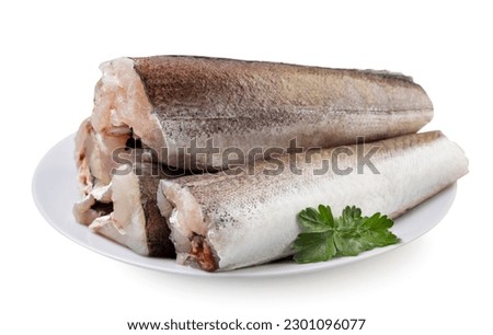 Hake fish carcasses with leaves in a plate close-up on a white background. Isolated
