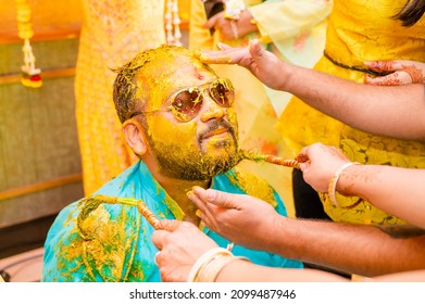 Haldi ceremony of an Indian wedding every one is putting haldi on an Indian groom before wedding