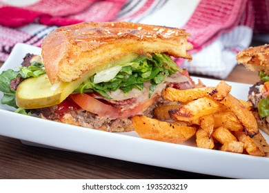 Half Beef Burger Closeup With Home Made Turnip Fries Plate On Table