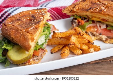 Half Beef Burger Closeup With Home Made Turnip Fries Plate On Table