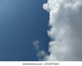 Half blue sky, half white cloud - Shutterstock ID 2312074261