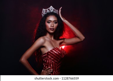 Half Body of Miss Pageant Contest in Asian Red Glitter Evening Ball Gown dress with Diamond Crown sash, fashion make up face eyes love heart hair style, studio lighting Black background back light - Shutterstock ID 1128766559