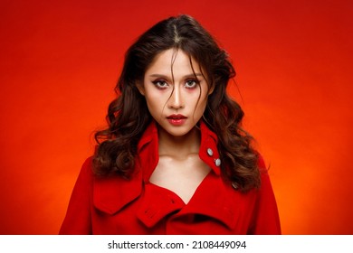 Half Body Portrait Of 20s Fashion Indian Woman Honey Skin Has Beautiful Black Hair Style. Asian Girl Express Strong Feeling, Fashion Poses Over Red Reddish Background Color Block