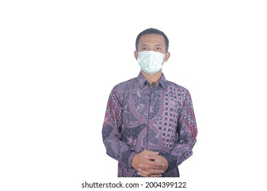 Half body portrait of South East Asian male model wearing batik shirt, Indonesian traditional clothes and mask