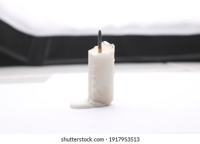 Half Burnt Candle With Wax On The Floor