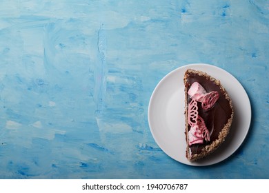 Half Of Cake On White Plate On Blue Painted Background. Sweet Bakery Minimalistic Shot, Top View, Copy Space.