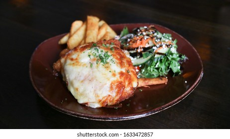 Half Chicken Parma Serves With Chips And Veggies. 