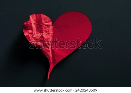 half crumpled heart on black