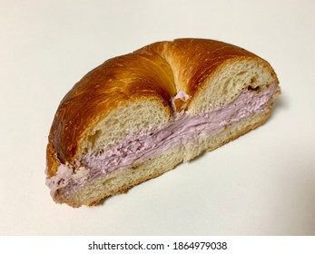 Half Cut Bagel With Blueberry Cream Cheese On White Background