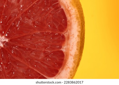 Half cut sliced ruby red grapefruit pulp macro closeup  yellow babackground 