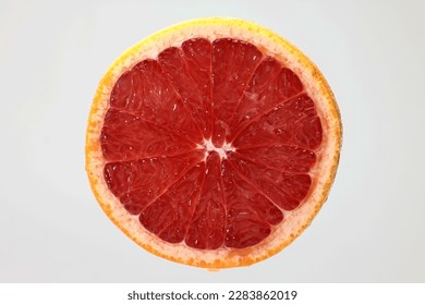 Half cut sliced ruby red grapefruit pulp macro closeup 