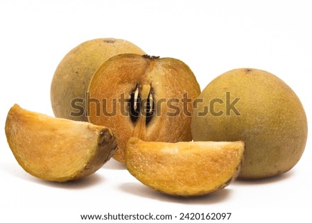 Half cut sliced and two whole fresh organic sapodilla delicious fruit isolated on white background clipping path